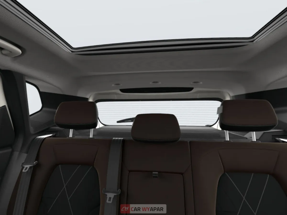 View of the rear passenger cabin in the Techno Plus trim, featuring three headrests and premium dark-toned upholstery.